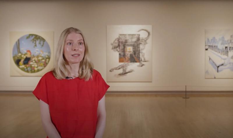 Allison Katz stands in front of three of her works on display at Mixing It Up: Painting Today at Hayward Gallery