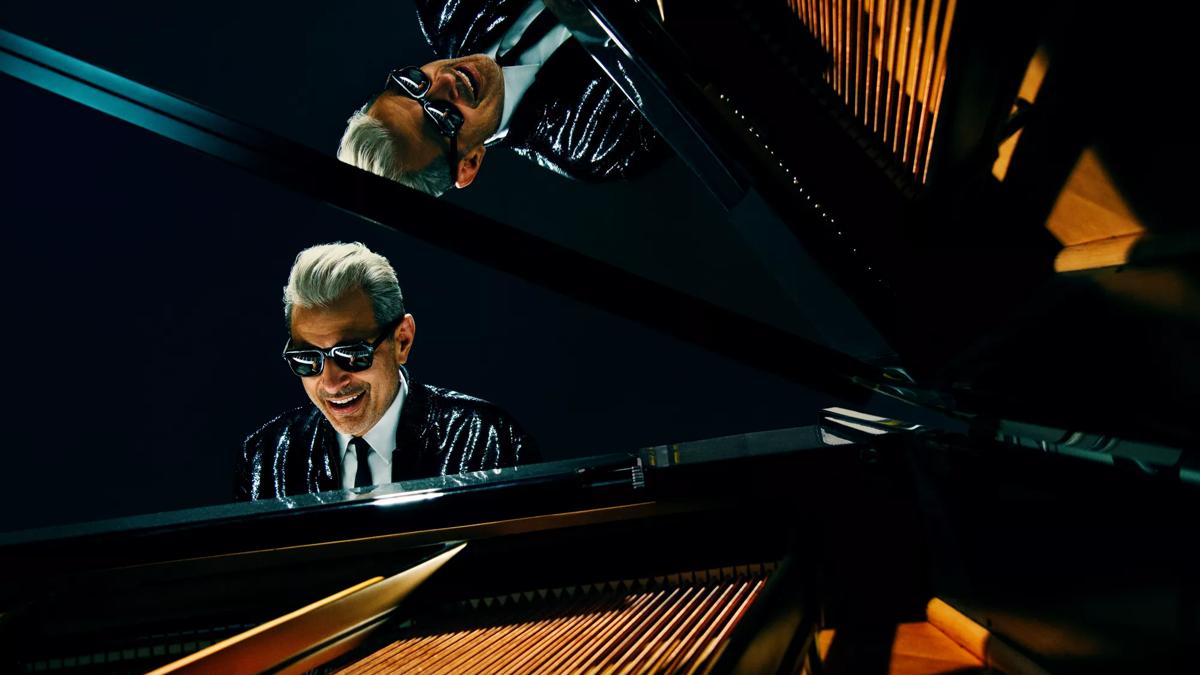 Actor Jeff Goldblum in sunglasses at a grand piano