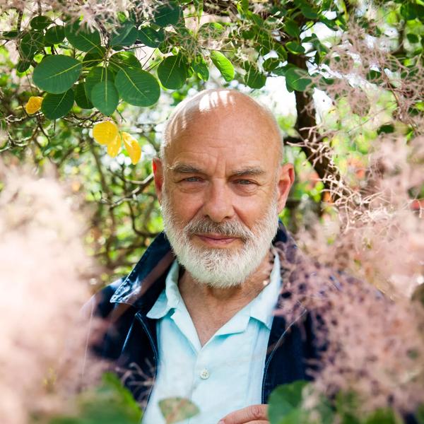 Brian Eno surrounded by greenery