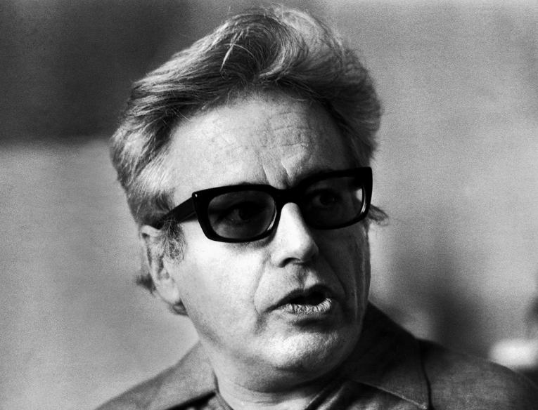 A black and white photo of a man wearing sunglasses